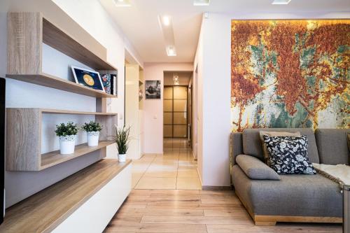 a living room with a couch and a map on the wall at Stawowa Premium Apartment - 69 m2 with sauna and private garage in Kraków