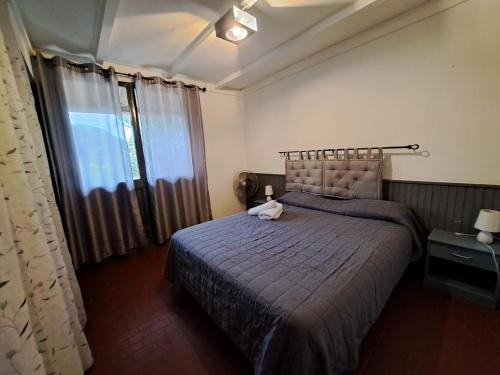 a bedroom with a bed and a large window at Bungalows Filippi in Porto-Vecchio