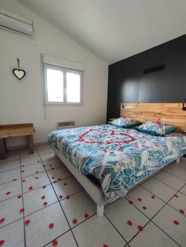 een slaapkamer met een bed met een bloemdekbed bij La Villamour avec jacuzzi in Gigean