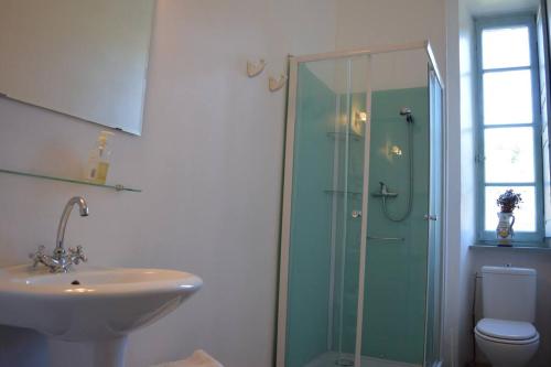 a bathroom with a glass shower and a sink at Riverside 4 bed house full of character and charm in Quillan