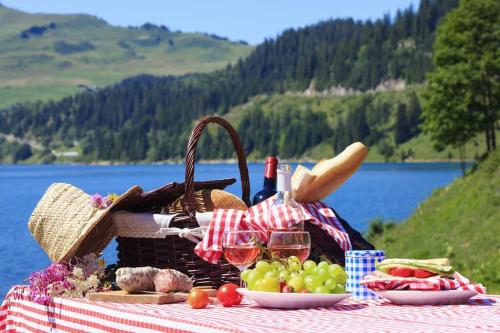 a picnic table with a basket of food and wine at Riverside 4 bed house full of character and charm in Quillan
