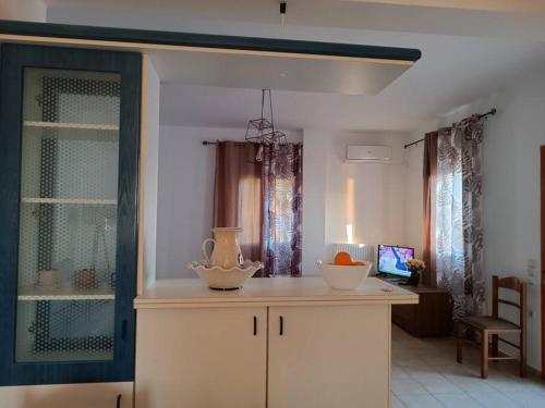 a kitchen with a counter with two bowls on it at Aegean Star in Apróvaton