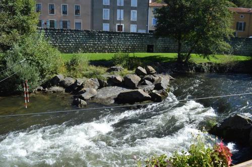 a stream of water with rocks in a river at Riverside 4 bed house full of character and charm in Quillan