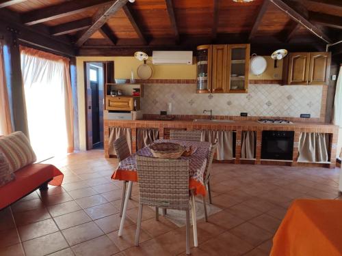a kitchen with a table and chairs in a room at villa solare in Castellammare del Golfo