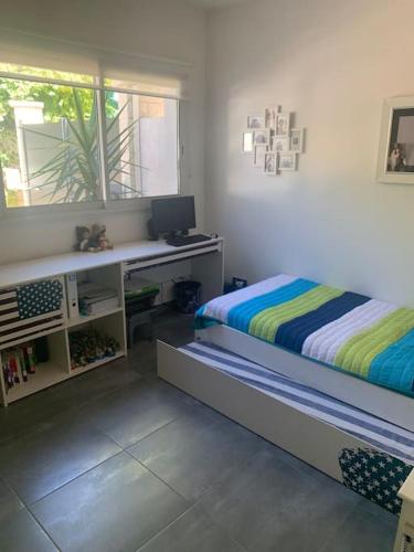 une chambre avec un lit, un bureau et une fenêtre dans l'établissement Magnifique Villa privée avec Piscine proche Plage, à Marseille