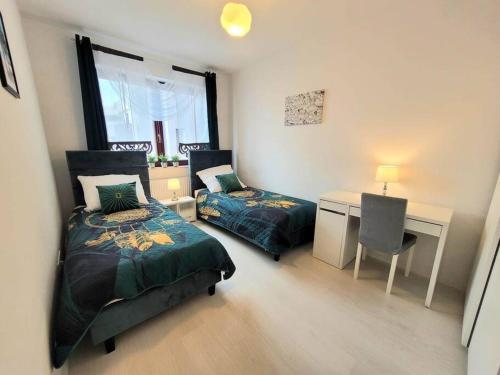 克拉科夫的住宿－Apartment Sophie 3 rooms, 2 bathrooms, 8 persons，一间卧室配有两张床、一张桌子和一张书桌。