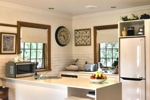 a kitchen with a counter with a bowl of fruit at Forth River Cottage in Forth