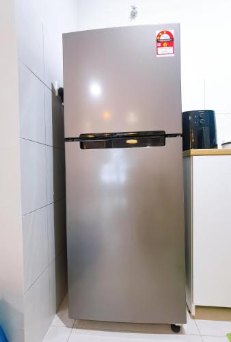 a stainless steel refrigerator in a kitchen at rumaKL at Majestic Maxim in Kuala Lumpur