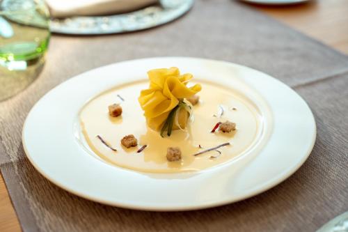a white plate with food on a table at Parc Hotel Billia in Saint Vincent