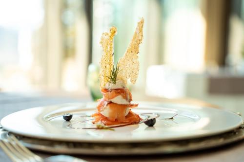 a plate with a piece of food on a table at Parc Hotel Billia in Saint Vincent