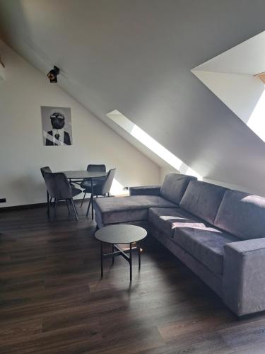 a living room with a couch and a table at Ösel Residence in Kuressaare