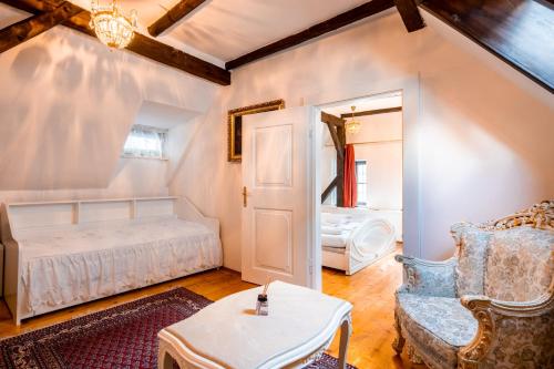 a bedroom with a bed and a chair and a table at Leylaria in Český Krumlov