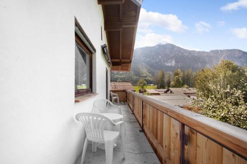 a balcony with chairs and a view of a mountain at Wohnung Hochstaufen in Inzell