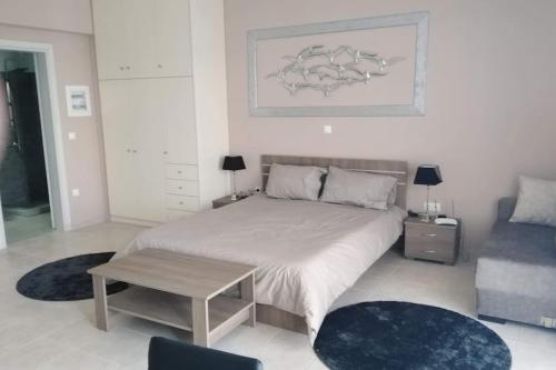 a bedroom with a large bed and a table at Brand new spacious studio in Itea