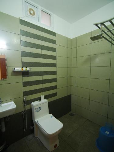 a bathroom with a toilet and a sink at Creek Way Munnar in Anachal