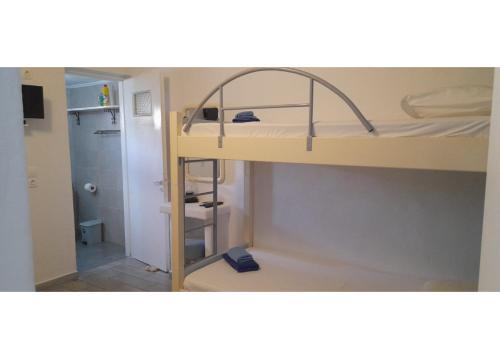 a small room with a bunk bed and a bathroom at Summer House Paliochori in Paliochori