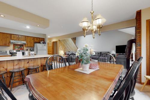 a kitchen and dining room with a wooden table at White Mountain Hideaway in North Conway