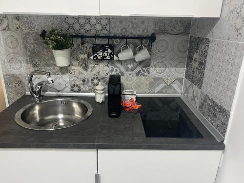 a kitchen counter with a sink and a counter top at Gargallo Suite Ortigia in Syracuse