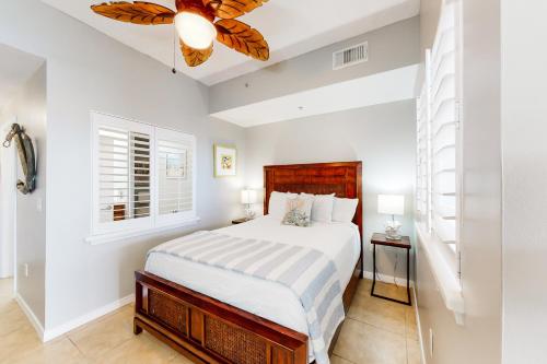 a bedroom with a bed and a ceiling fan at Destin West Gulfside Villa V402 in Fort Walton Beach