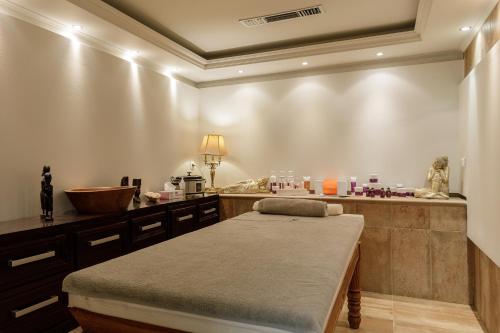 a room with a table with a bed in it at Diverso Platamon, Luxury Hotel & Suites in Platamonas