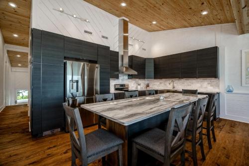 a kitchen with a large wooden table and chairs at Oceans 6 condo in Pine Knoll Shores