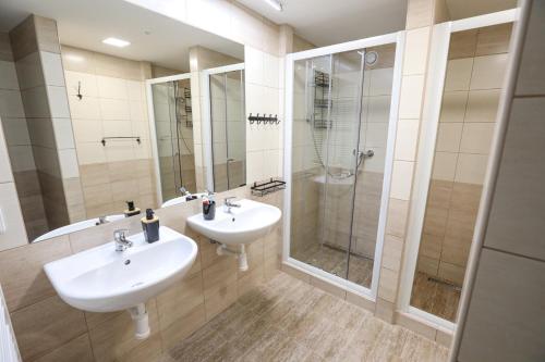 a bathroom with two sinks and a shower at Horská chata Medika in Horní Maršov