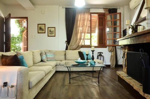 a living room with a couch and a fireplace at Antalia Home in Kalamata