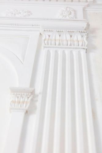 a close up of a white building with columns at Château de Collias in Collias