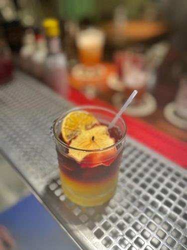 a drink with an orange slice on a metal tray at International Citizen Hotel in Kaohsiung