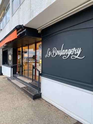 a store with a sign on the side of a building at Vue panoramique mer et chenal même de la chambre 50m2 refait à neuf situation idéale en option garage fermé privé in Les Sables-dʼOlonne