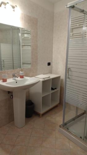 a bathroom with a sink and a shower at AGORÀ suite in Gardone Riviera