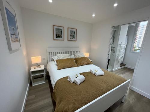 - une chambre avec un grand lit et des serviettes dans l'établissement Joli appartement Chez Dam, à Caen