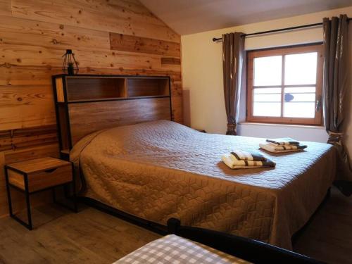 a bedroom with a bed with two towels on it at Agréable maison de village. in Castellane