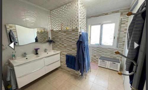 a bathroom with a sink and a mirror at Villa ALCANAR PLATJA in Les Cases d'Alcanar