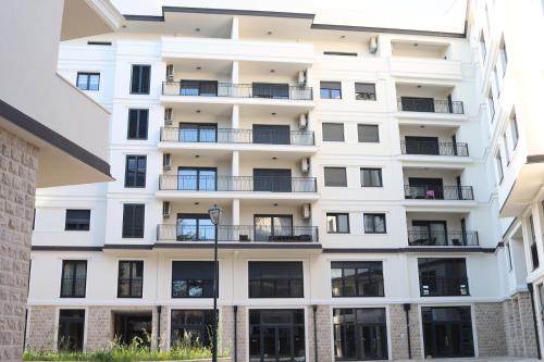 an exterior view of a white building with balconies at Trebinje Lux Apartment in Trebinje