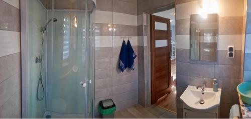 a bathroom with a shower and a sink at Zator Sleepover in Zator