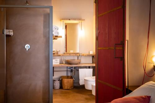 a bathroom with a sink and a toilet in a room at Agriturismo Sweet Cottage in Marina di Grosseto