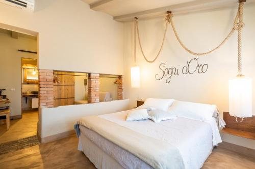 a bedroom with a bed with a sign on the wall at Agriturismo Sweet Cottage in Marina di Grosseto