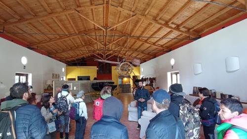 a group of people standing in a room at Chiosi Country Club in Corleone