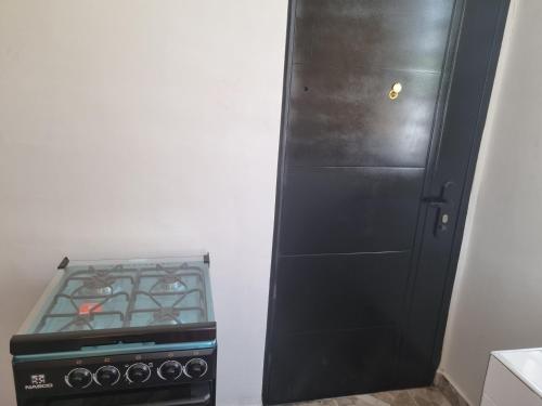 a black cabinet next to a stove in a kitchen at nanas@TEMA C11 in Tema