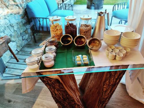 a table with bowls and jars of food on it at Chalet Le Coccole in Sappada