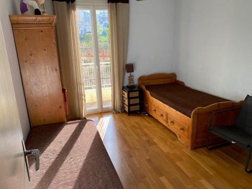 a bedroom with a bed and a window and a chair at Le Minerve in Menton