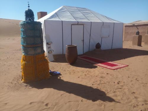 a building in the middle of the desert at Desert Erg Chegaga Camp in El Gouera