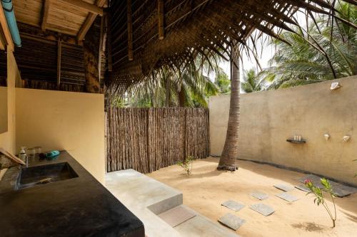 a patio with a sink and a palm tree at Elements Beach & Nature Resort in Kalpitiya