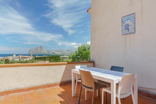 a white table and chairs on a balcony at La Pineta al Mare in Erice