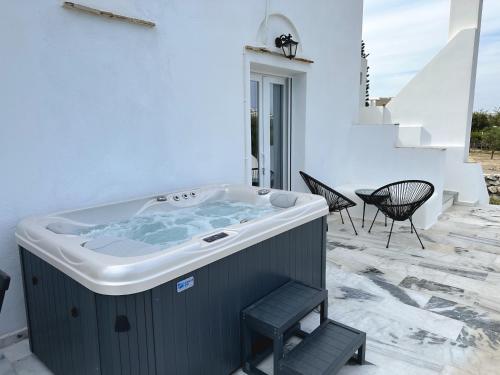 a jacuzzi tub on the patio of a house at Naxian Touch in Agia Anna Naxos