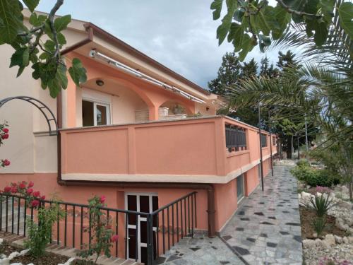 a house with a balcony on the side of it at Sany&Toyo in Barbat na Rabu