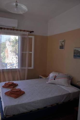 a bedroom with a bed with two towels on it at Evdilos apartments with a view in Evdilos
