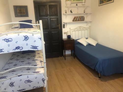 a bedroom with two bunk beds and a door at IL Kent in Ischia