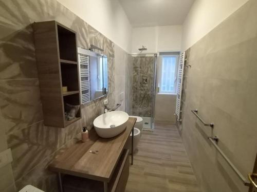 a bathroom with a sink and a toilet and a shower at Casa Sorelle Marchisio in Rome